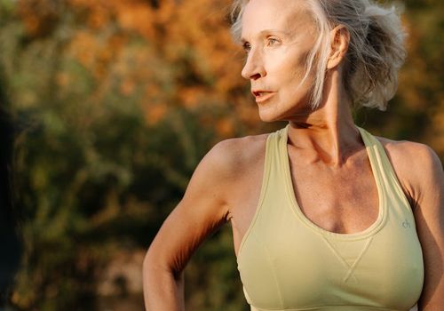 Mature person exercising gently in a garden